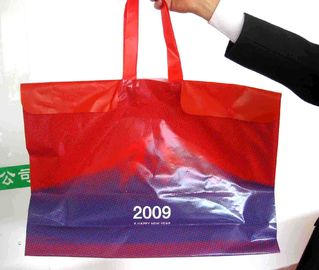 La aduana imprimió bolsos de compras plásticos grandes con las manijas/botón de la cuerda